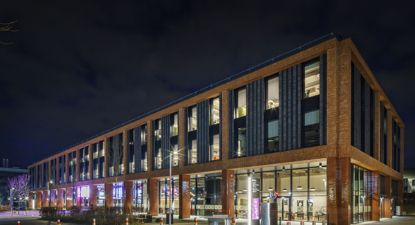 An exterior view of the Catalyst building at night time