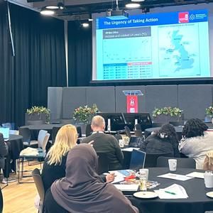 Delegates pictured at Staffordshire University's Carbon Literacy community day watching a presentation showcasing 'The Urgency of Taking Action'