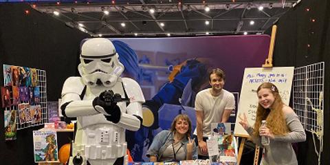 Students pictured with a Stormtrooper at the comic con event