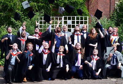 Computer games graduates and staff throwing their hats in the air