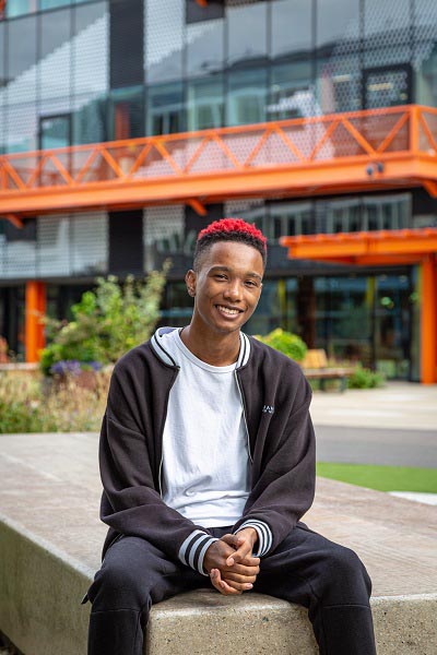 James Henry sat in front of the Here East campus