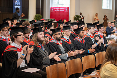 Staffordshire University London graduates wearing caps and gowns