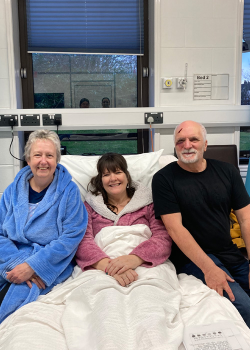 Three service users are engaging in a nursing simulation