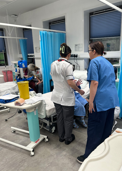 Nurses are engaging in a medical simulation in the University ward