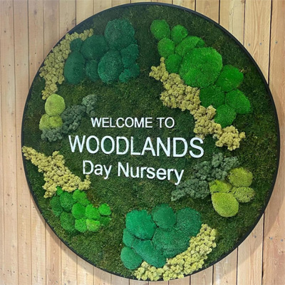 Welcome to Woodlands Day Nursery sign on the wall
