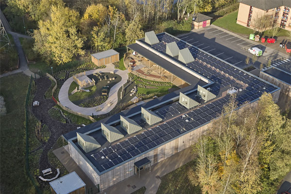 A birds eye shot of the Woodlands Nursery surrounded by trees and University campus buildings