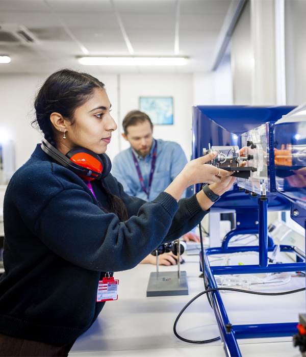 A female is using equipment in the mechanical engineering lab