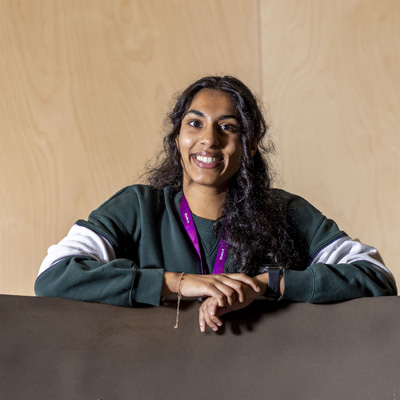 A female student with dark hair is smiling