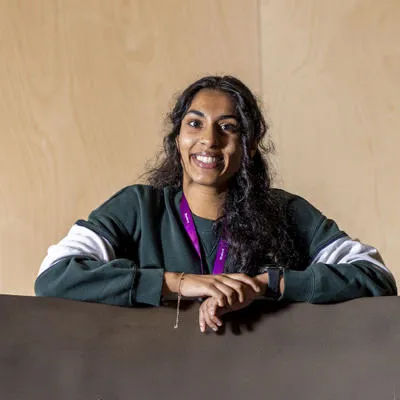 A female student with dark hair is smiling