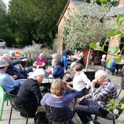 The cohort from the 1973/4 Geography and Modern Studies sitting around a table outside.