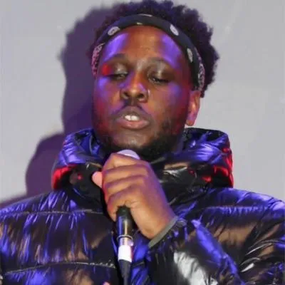 Banji is performing holding a microphone