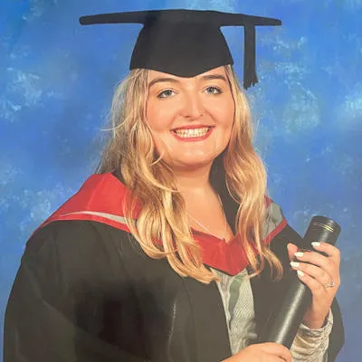 Lauren wearing a graduation cap and gown