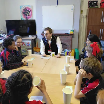 Seb chatting to children sat at the table