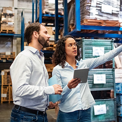 male and female colleagues talking in a warehouse
