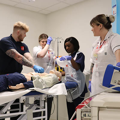 clinical team take part in a training exercise using a medical dummy