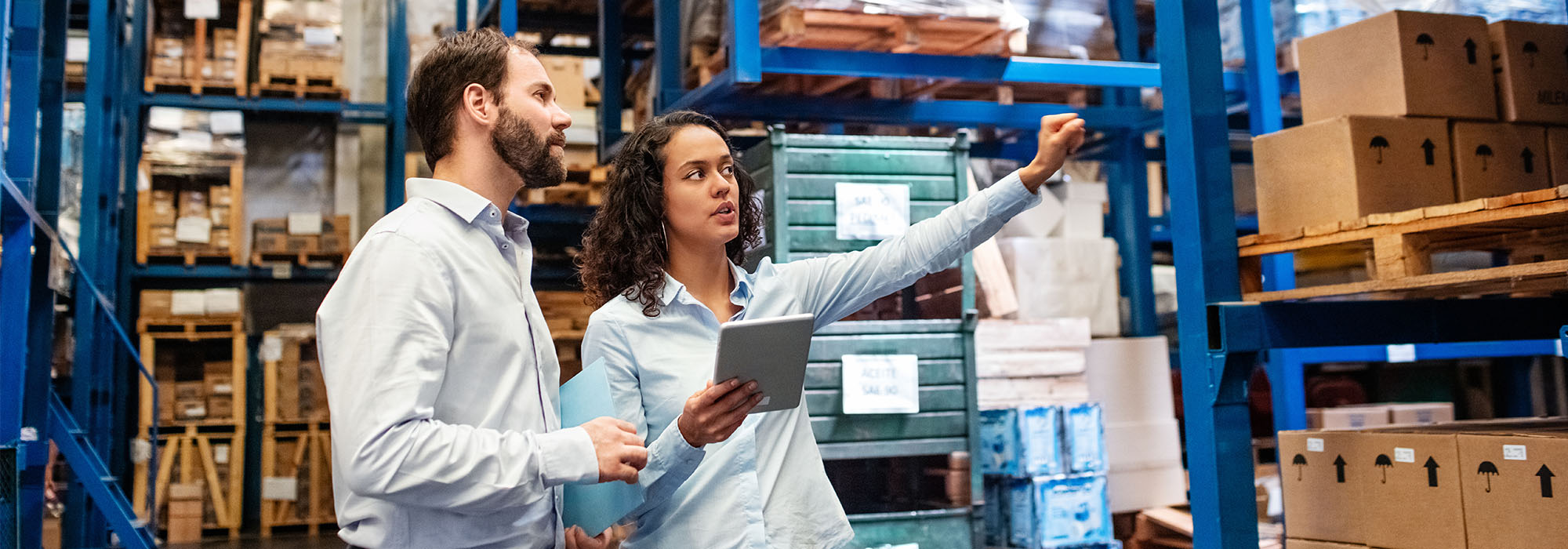 male and female colleagues talking in a warehouse