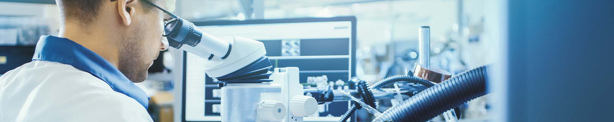 researcher using microscope