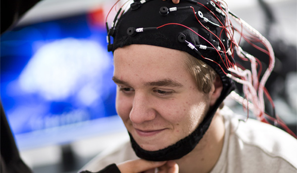 A male student is having a neuro cap fitted in the psychology lab