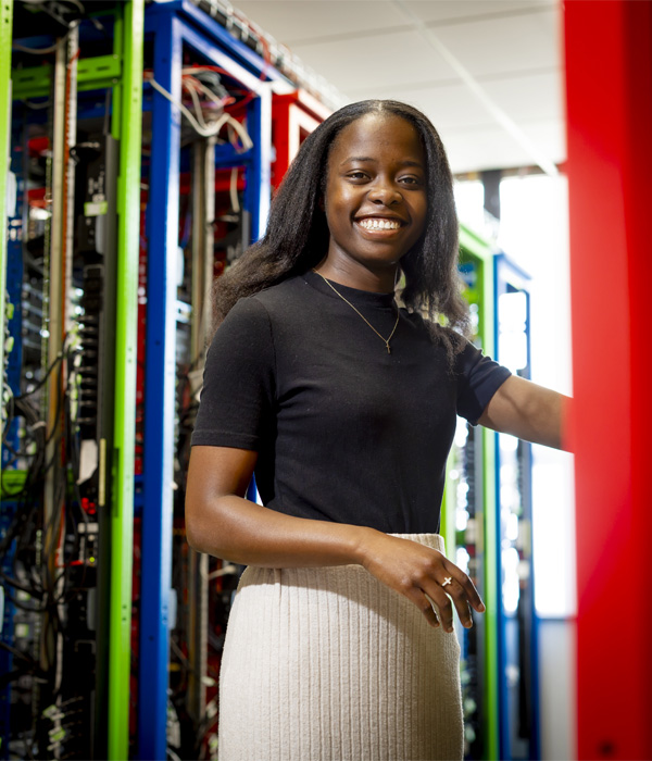 jemina is smiling whilst working in the networking lab