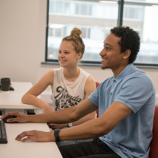 A pair of students using computers at Staffordshire University