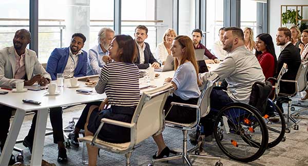group of mixed business professionals sitting around a meeting table
