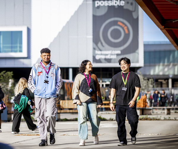 Students are walking outside the Here East campus on a busy day