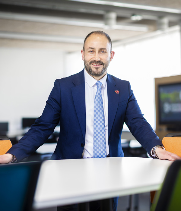 Headshot of academic Joe Hazzam wearing a suit
