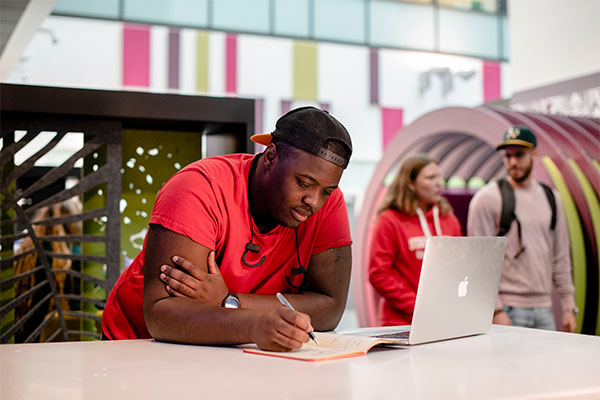 Male postgraduate student working on a laptop in the Science Centre