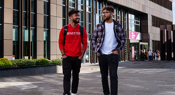 two male students walking past the science centre
