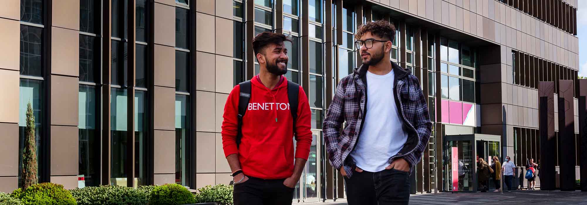 two male students walking outside of the Science Centre at our Stoke-on-Trent campus