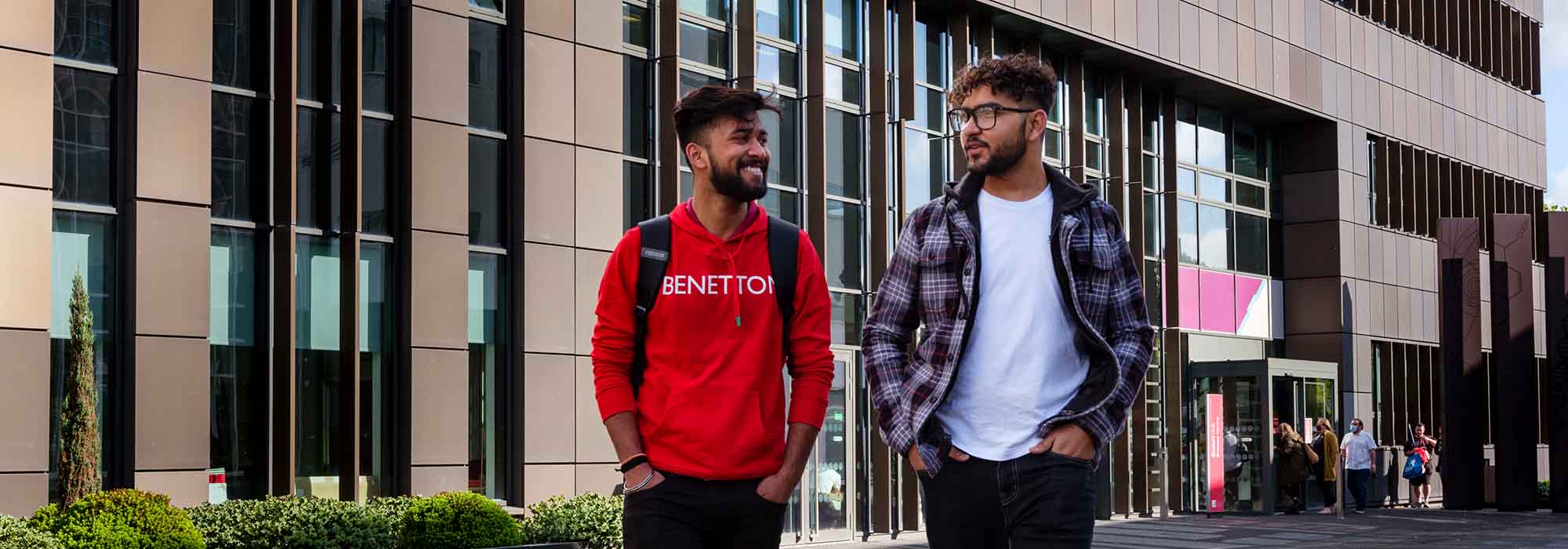 two male students walking outside of the Science Centre at our Stoke-on-Trent campus