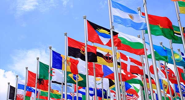 A range of international flags blowing in the wind