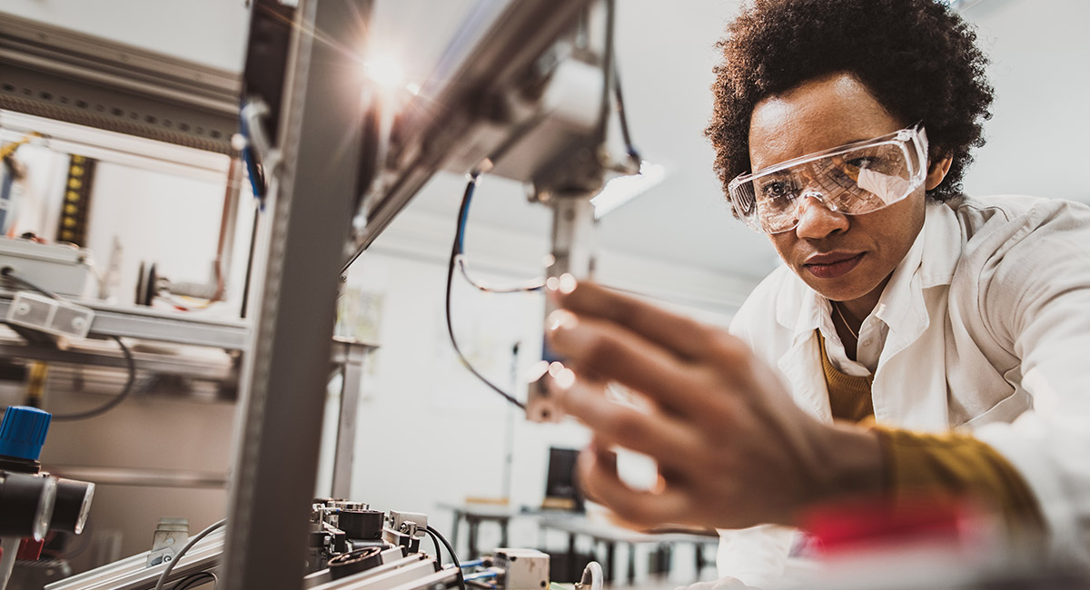 female researcher using machinery in the lab