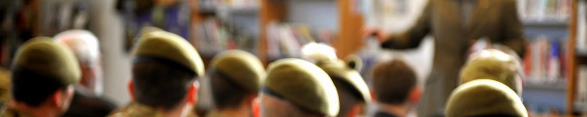 A group of HM Forces staff in front of a speaker