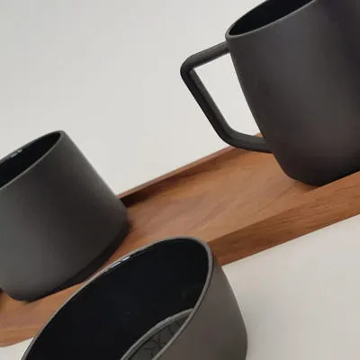 Coffee set for Wedgwood made in Black Jasper with a walnut tray by Ross Mountford.