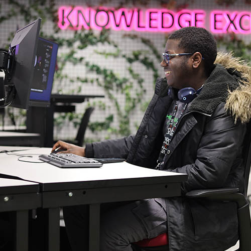 male student using multi-screen machine at Staffordshire University London