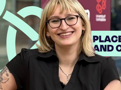 Computing student Aura, is wearing glasses and smiling