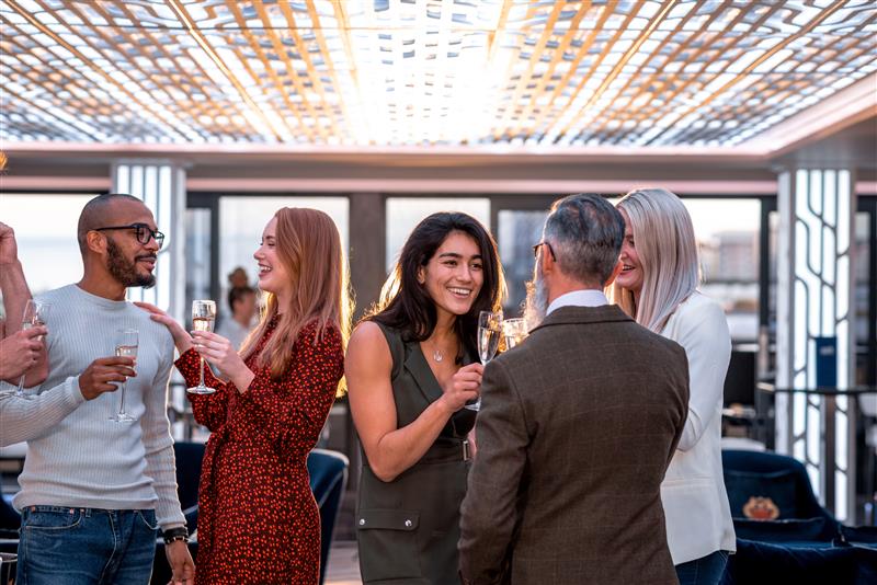 An image of people drinking from champagne flutes