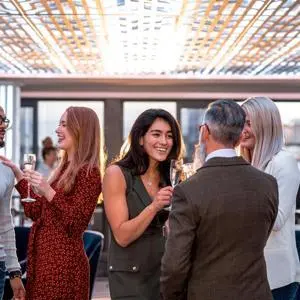 An image of people drinking from champagne flutes