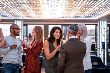 An image of people drinking from champagne flutes