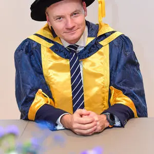 Alex Murray OBE in his honorary doctor camp and gown