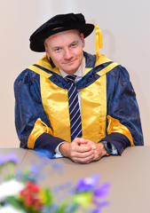 Alex Murray OBE in his honorary doctor camp and gown