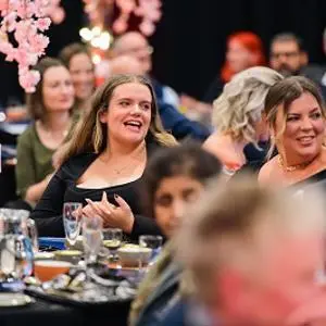 people seated at tables looking happy