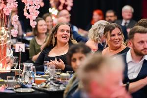 people seated at tables looking happy