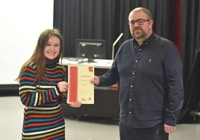 Bethan Surr receiving her winner's certificate from Mike McDonald