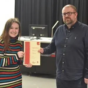 Bethan Surr receiving her winner's certificate from Mike McDonald