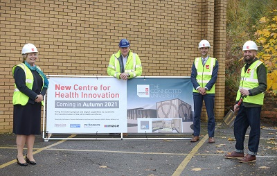 Staffordshire University and Pave Aways personnel pictured with a banner depicting an artist impression of the new Centre for Health Innovation facility.,