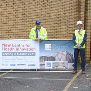 Staffordshire University and Pave Aways personnel pictured with a banner depicting an artist impression of the new Centre for Health Innovation facility.,