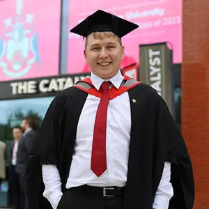 Brandon Briggs in his graduation cap and gown