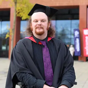 Cai Brown in his graduation cap and brown